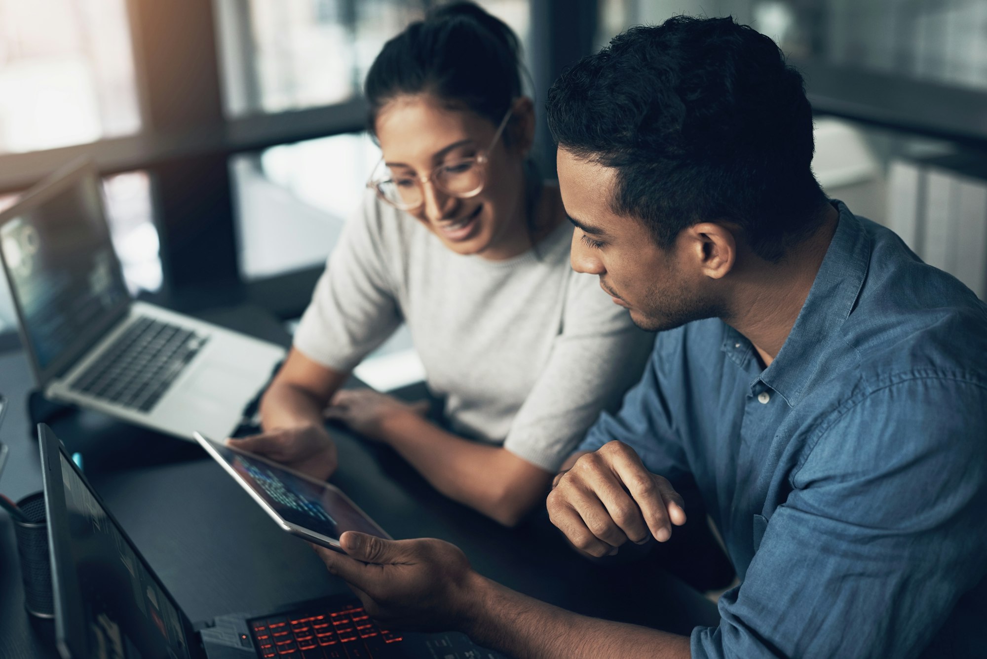 shot-of-two-young-workers-using-a-digital-tablet-in-a-modern-office.jpg